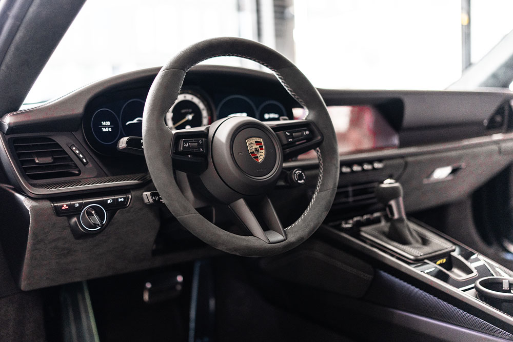 Photo of a sports car's alcantara leather interior.